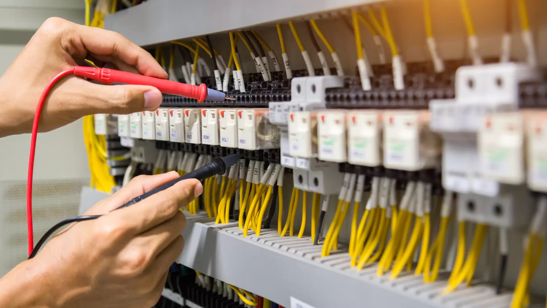 electricians-hands-testing-current-electric-control-panel.jpg